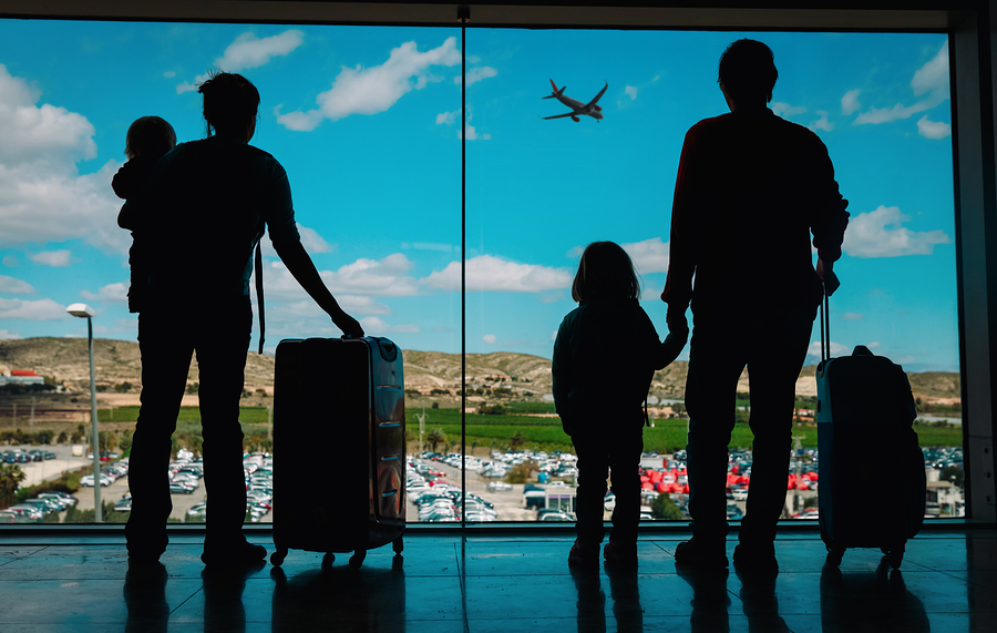 Parents and children wait for their flight to board